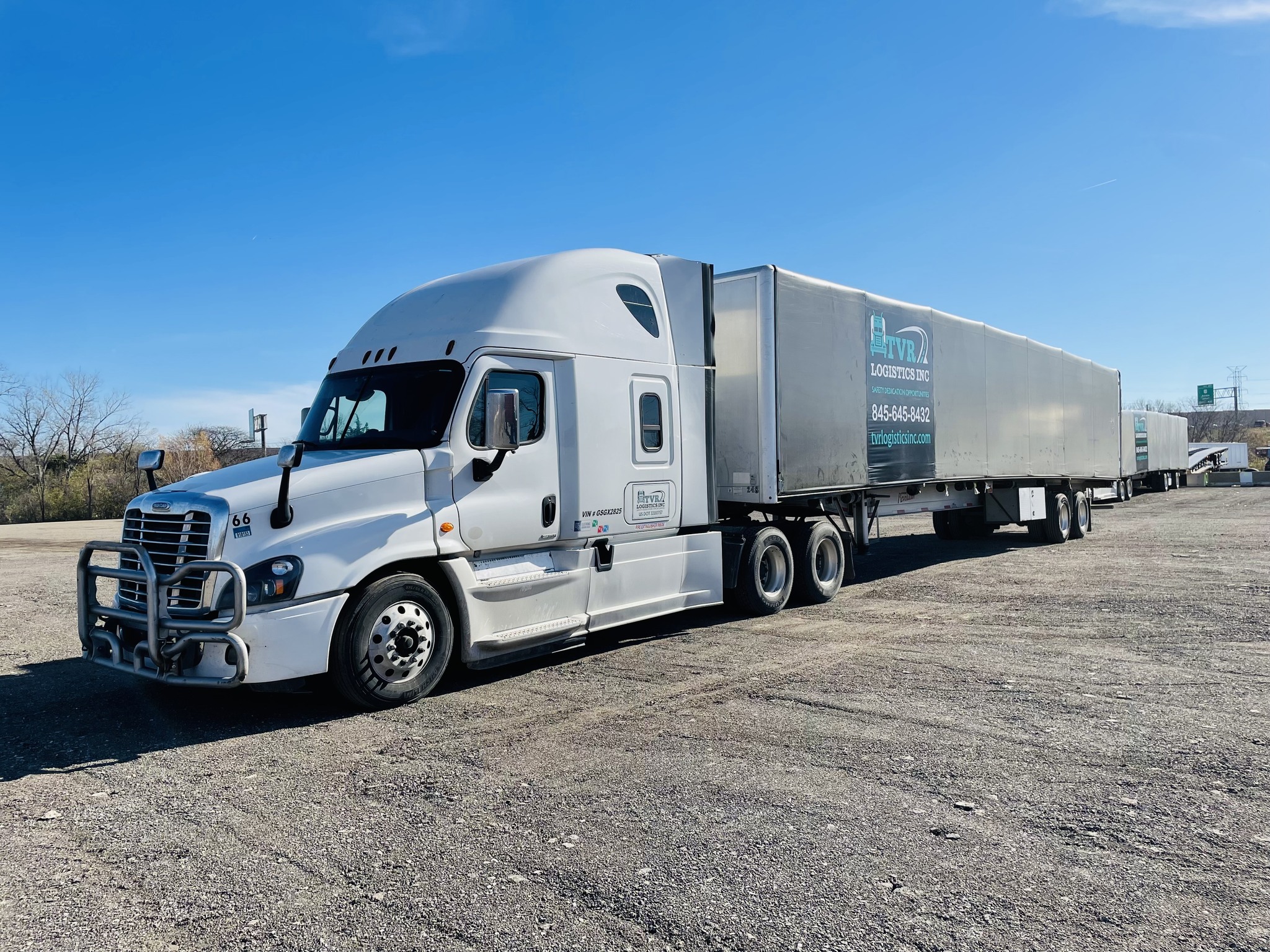 TVR Logistics step-deck trailer hauling heavy equipment
